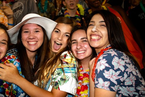 Lexi Siefer, junior, Arielle Reames, junior, Connar Gigous, junior, and Jessica Barriga, senior all pose for a picture in the stands during the Topeka High v Emporia game.