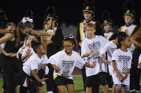 The kids perform "Shake it Off" at half time of the game 