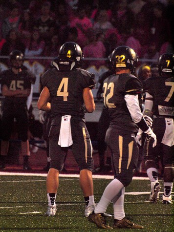 Jacob Anderson (4) and Brady Packard (32), senior, checking to the sideline for the defensive play call. Packard had 3.0 sacks on the night.