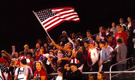 Matthew Gonzales, senior, waves an American flag to celebrate a 34-10 win over Washburn Rural, which puts Topeka High at 8-0 on the season.