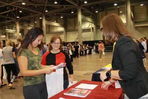 Ale Villegas and Francesca Kelly, seniors, take in a booth at the College & Career Fair at the Kansas Expocenter.