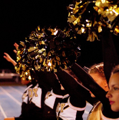 The Trojan Cheer Team shakes their pom-poms in anticipation of a kickoff.