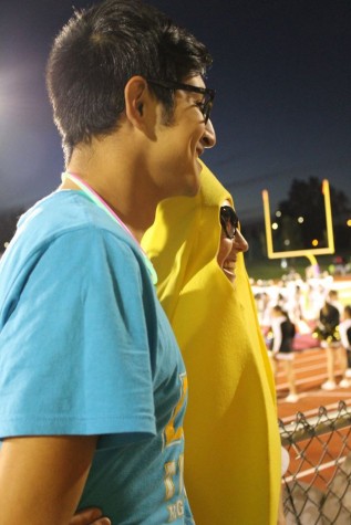 Jaime Ramirez, senior, getting a picture with Hannah Hooper, senior, who showed up to the game sporting a banana suit.