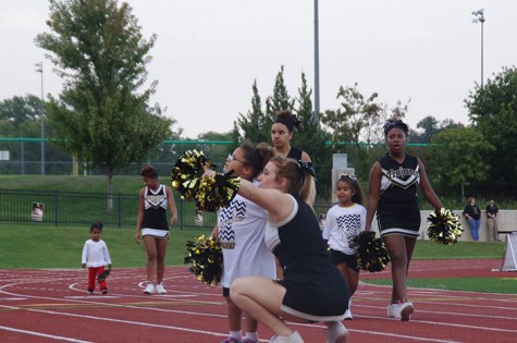 Kennedy Robinson, sophomore cheerleader, points the crowd out to a kid from the clinic 