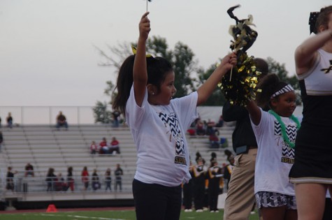 A girl from the kids clinic does the cheers she has learned