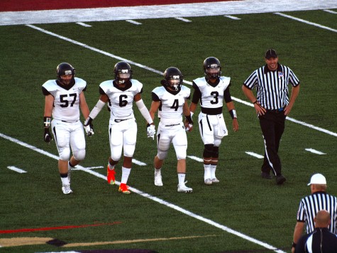 The Trojan team captains (From left to right: William Wagemaker, Dante Brooks, Jacob Anderson, and Corey Thomas) heading out for the coin toss at the start of the game.