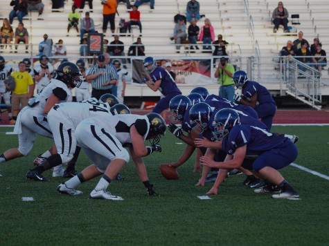 The Trojan defense lining up head to head with Topeka West's offense.
