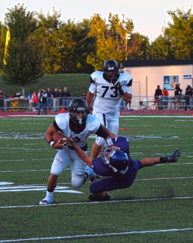 Saylor Carraway, senior, shoves a West defender to the ground on his way to a big gain.