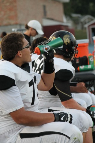 Teven Jenkins, senior, resting and rehydrating between offensive drives. 