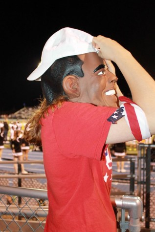 Ana Anthony, junior, wears a Barack Obama mask in the spirit of the "Red, White, and Blue" spirit section theme.