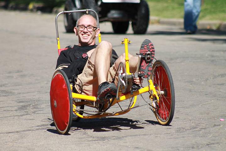 Jeremey Gibson, english teacher, rides his three wheeled cruiser on the 2015 Topeka High Homecoming Parade route.