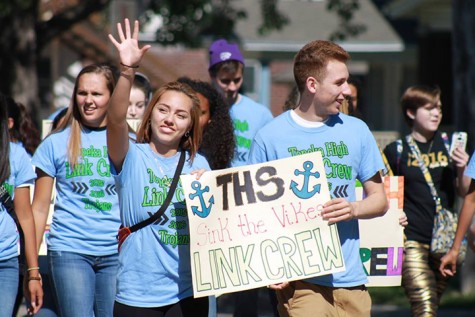 Seniors Casandra Hernandez and Mario King walking with Topeka High School's Link Crew on the Homecoming parade route.
