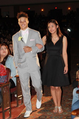 Saylor Caraway, senior, escorted by his cousin Justace Young, senior, during the 2015 Homecoming Assembly.