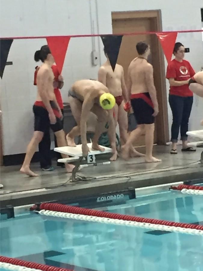 Dylan Hall, senior, get set to dive into the water for the 200 IM.
