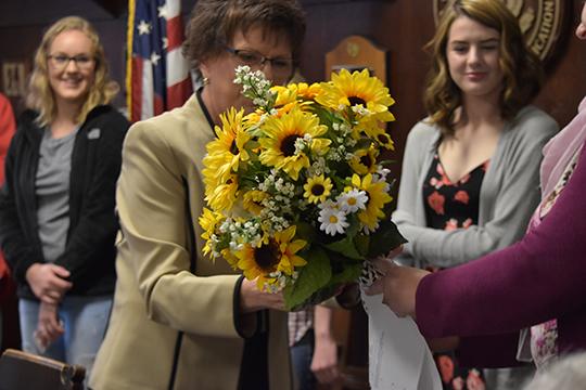 Dr. Wiley gets presented with flowers by Kristy Dekat, journalism adviser 