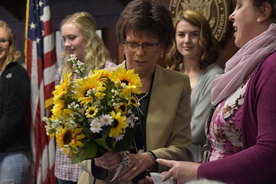 Dr. Wiley receiving flowers from the publication staffs.