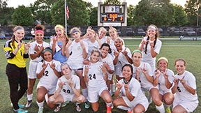 The schools womens varsity soccer team makes a W sign with their hands symbolizing their win against Topeka Wests team. The ladies hold a current record of 13-4. The record is the highest score recorded in schools system