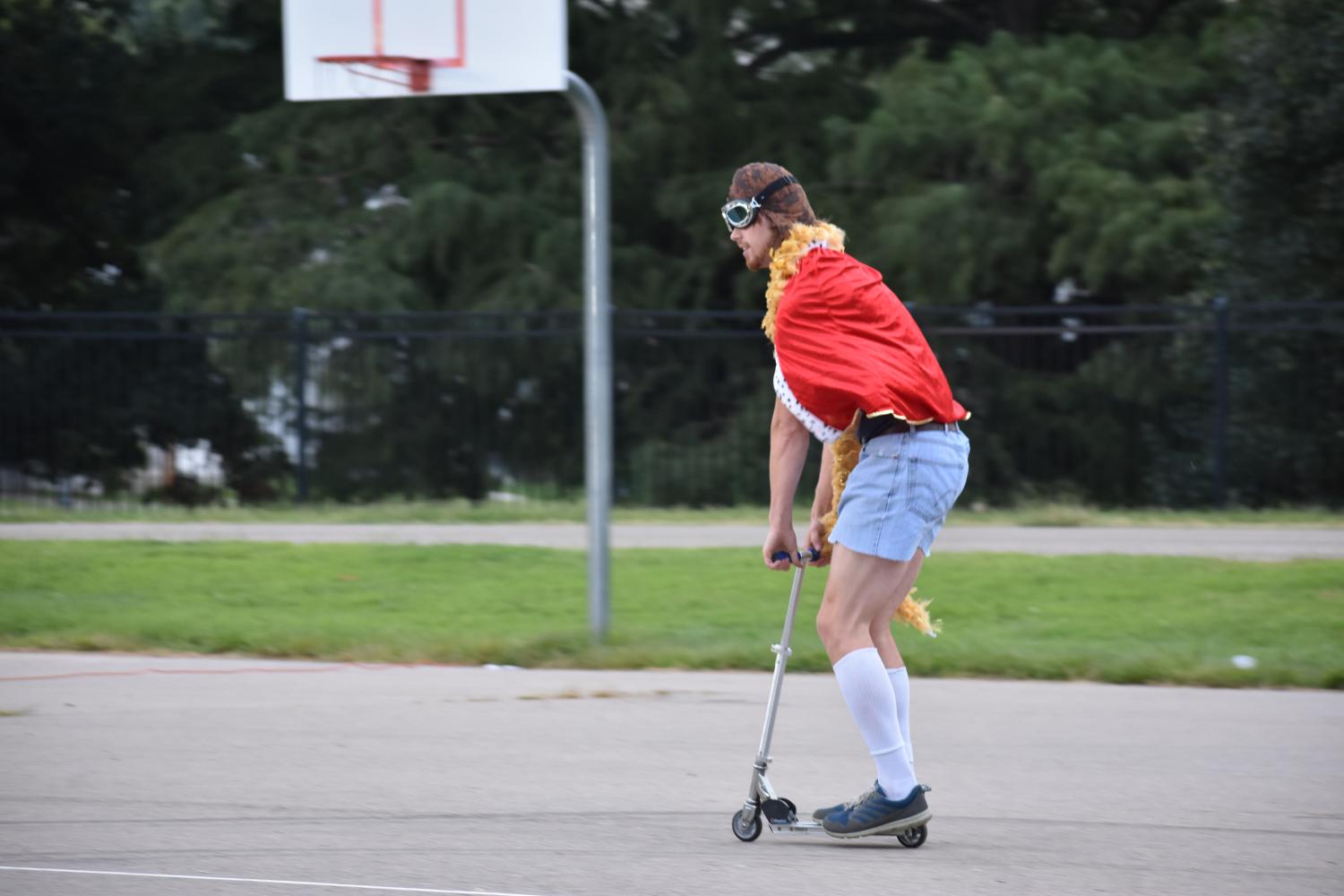 Evan Robinson, a young life leader, rides scooter as an introduction to Color Chaos. 