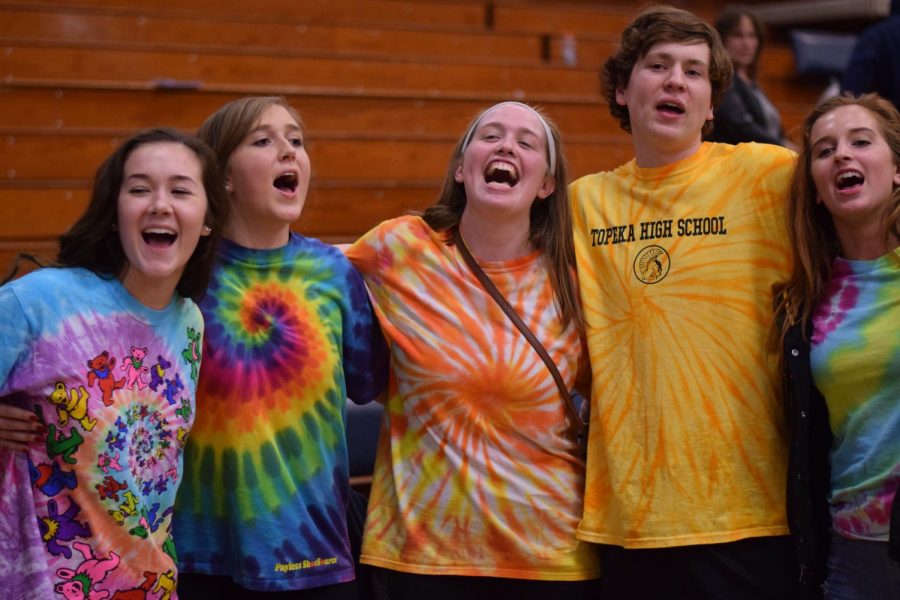 Seniors Grace Hatesohl, Julia Howell, Nell DeCoursey Brennan and Fischer Carr sing the school song on the court after the game had concluded. 