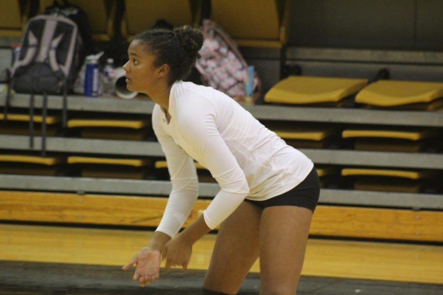 Tionna German(Senior) prepares to return a ball.