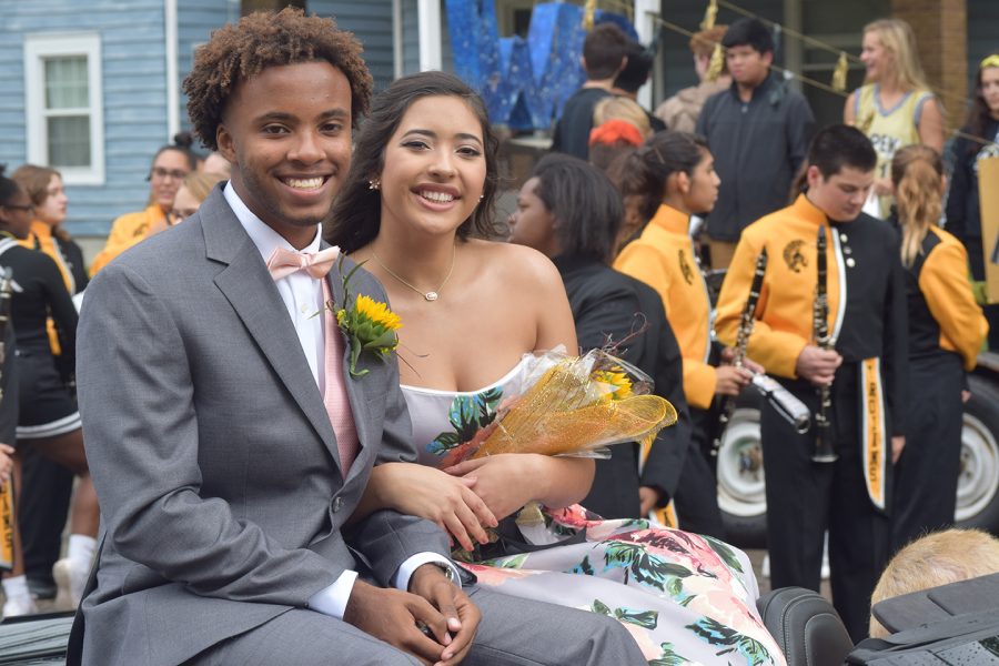 Candidates Philip Canady and Alexia Hercules smile at onlookers from their homecoming float.