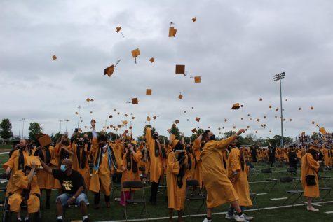 A group of graduates throwing their caps as the commencement ceremony ends.