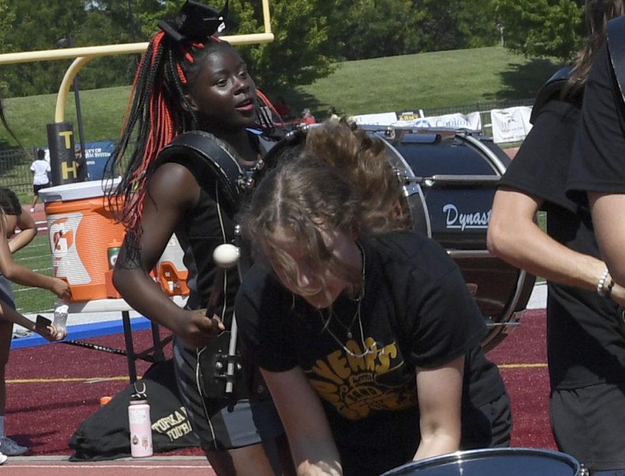 Latrice Hysten (11th) playing the bass drum at a performance with the drumline. 