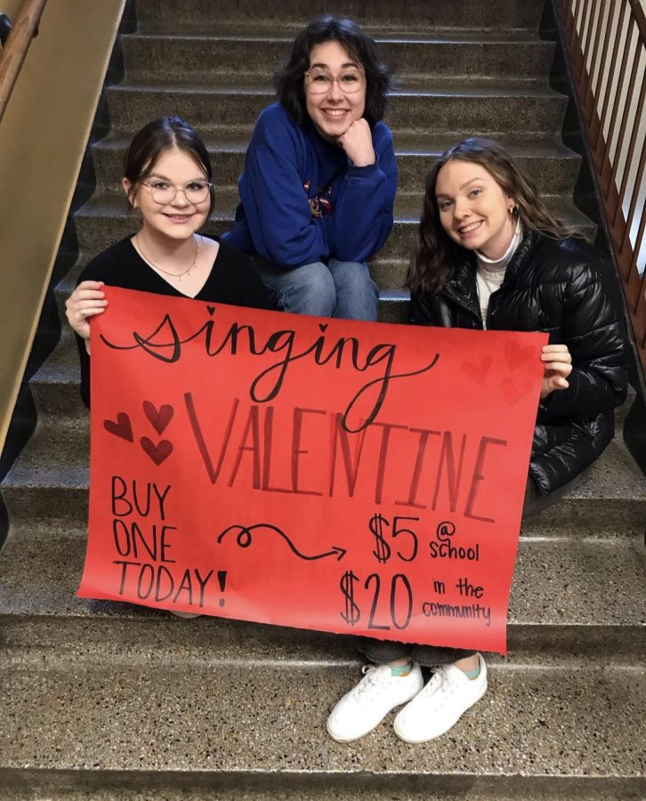 Jordan Jackson (10), Lilly Krohe (10), and Keira Trupp (12) all apart of Madrigals, advertising singing valentines. 