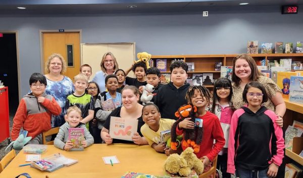 Bowling posing with a Williams Science and Fine Arts Magnet School after reading the book to them.