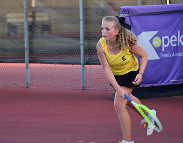 Madeline Deters, 12, the reigning centennial league tennis singles champion, watching the ball cross the net.