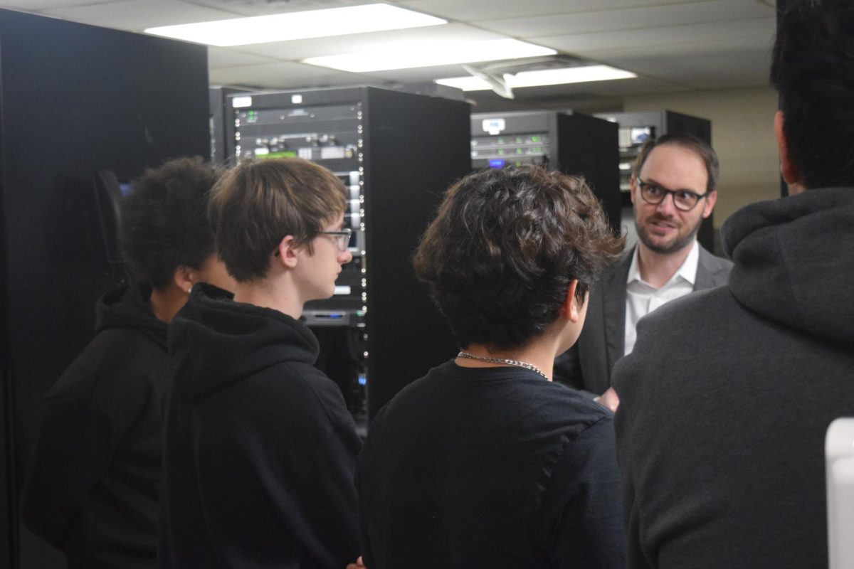 On a tour of the KSNT news station, junior Sam Stanton listens intently as News Director Jesse Fray explains the ins and outs of the control room.