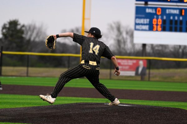 Senior Elisha Guest mid-pitching motion in an away matchup at Washburn Rural.